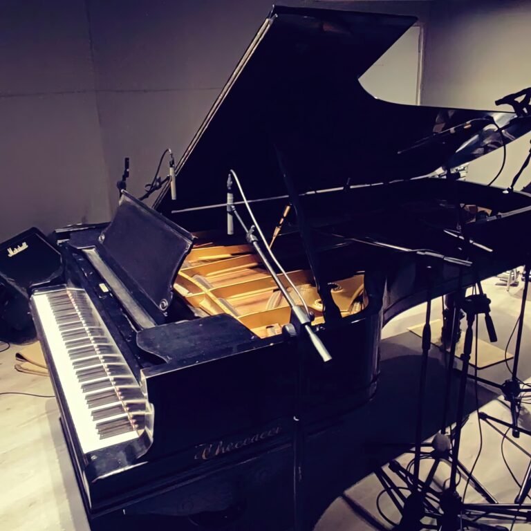 Grand piano miked up in the Studio A live room