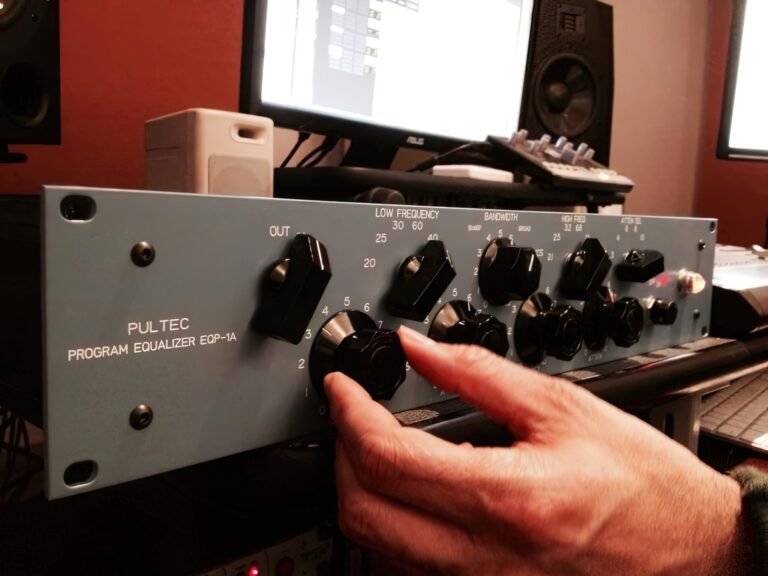 Adjusting a Pultec EQP-1A equalizer in the control room